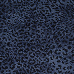 Wool-blend broadloom carpet swatch in a dense leopard print in black on a navy field.