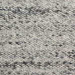 Wool broadloom carpet swatch in a textured stripe weave in mottled cream and charcoal.