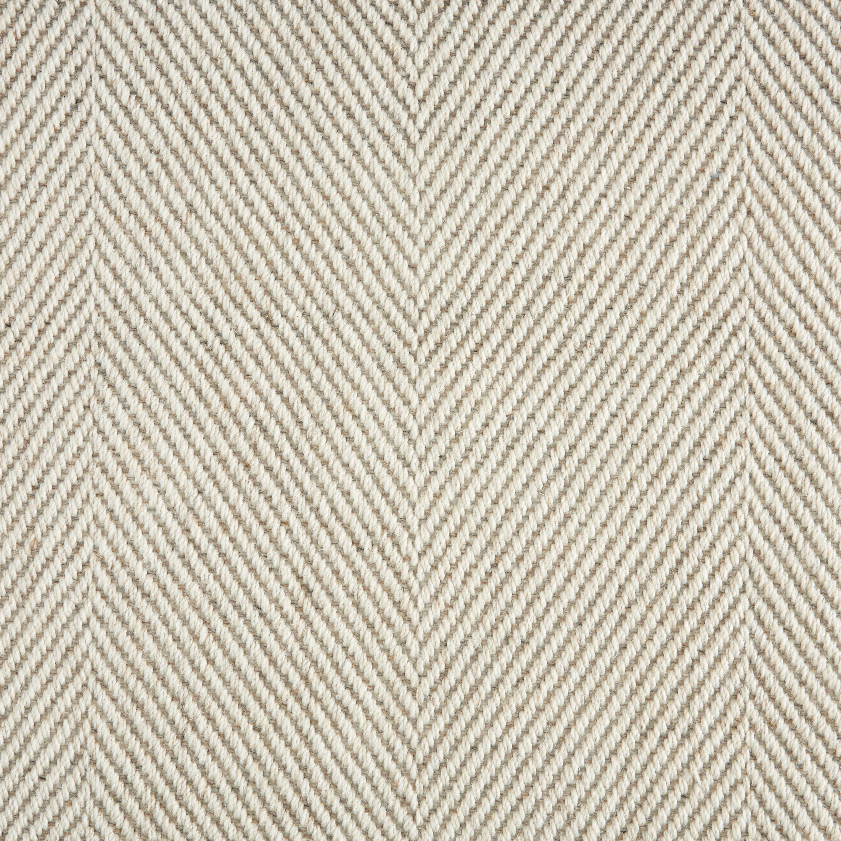 Wool-blend broadloom carpet swatch in a flat herringbone weave in cream and tan.
