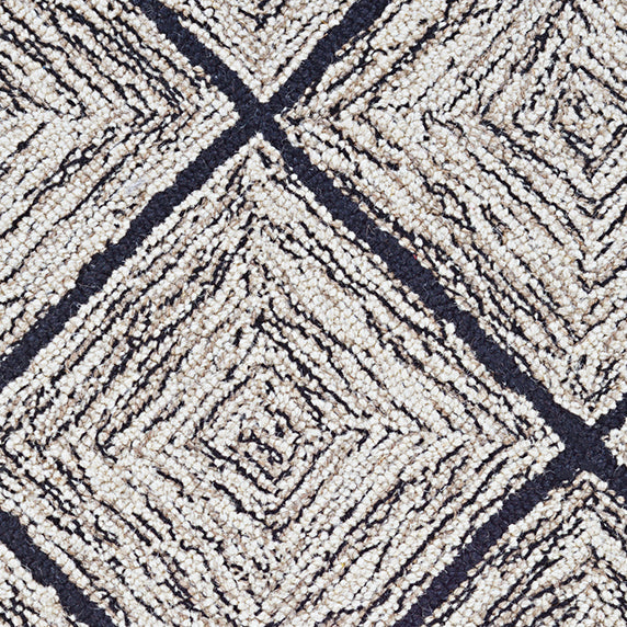 Wool broadloom carpet swatch in a diamond lattice print in cream and gold on a charcoal field.
