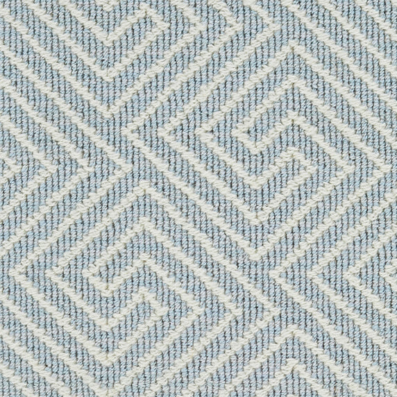 Wool broadloom carpet swatch in a high-pile interlocking geometric pattern in cream and light blue.