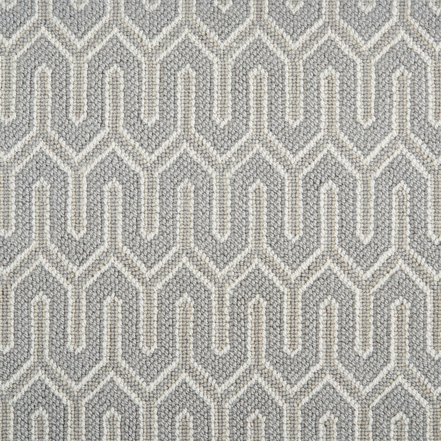 Wool-blend broadloom carpet swatch in a chunky geometric linear weave in tan and gray.