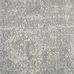 Wool-blend broadloom carpet swatch in a dimensional abstract weave in gray and cream.