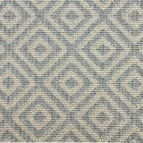 Wool-blend broadloom carpet swatch in a repeating diamond print in blue on a cream field.