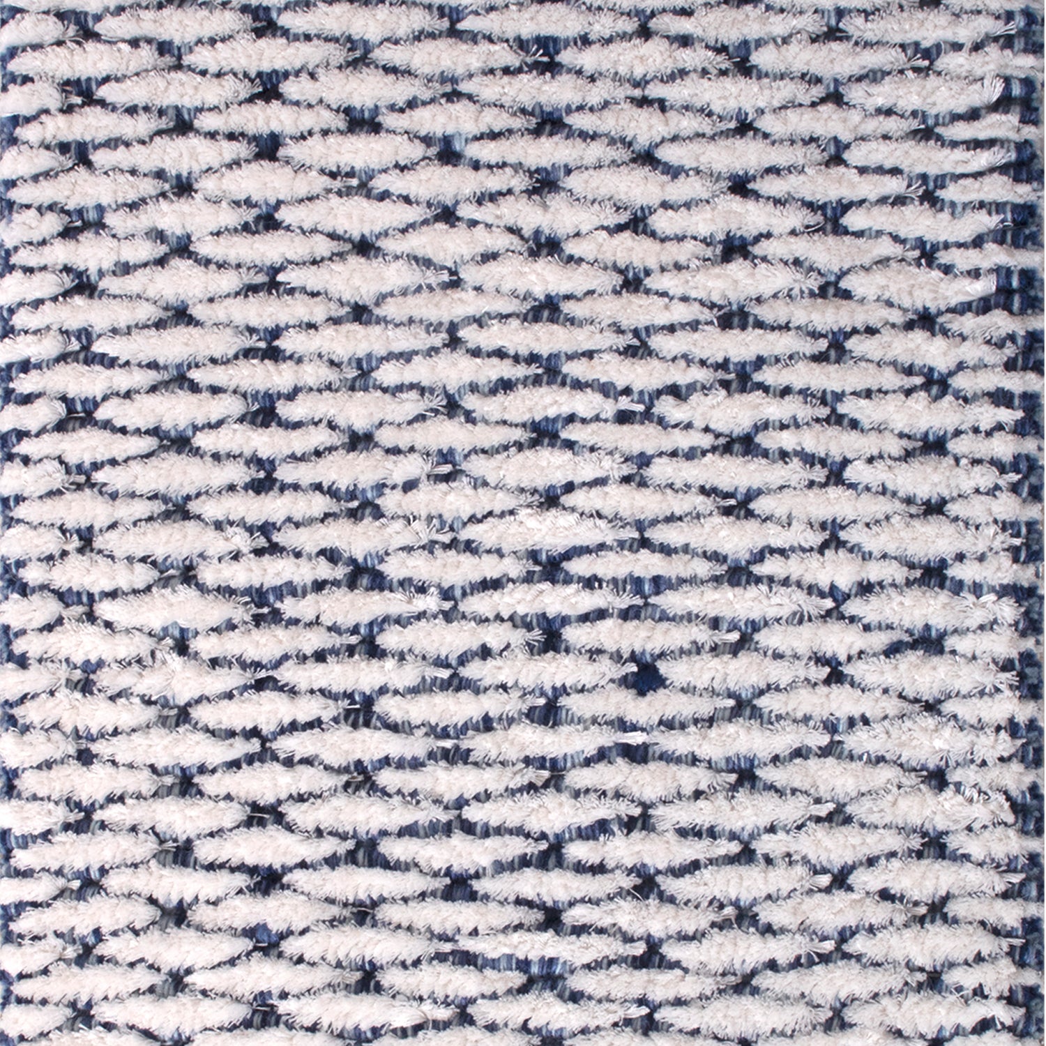 Wool-blend broadloom carpet swatch in a textured lattice print in navy on a white field.