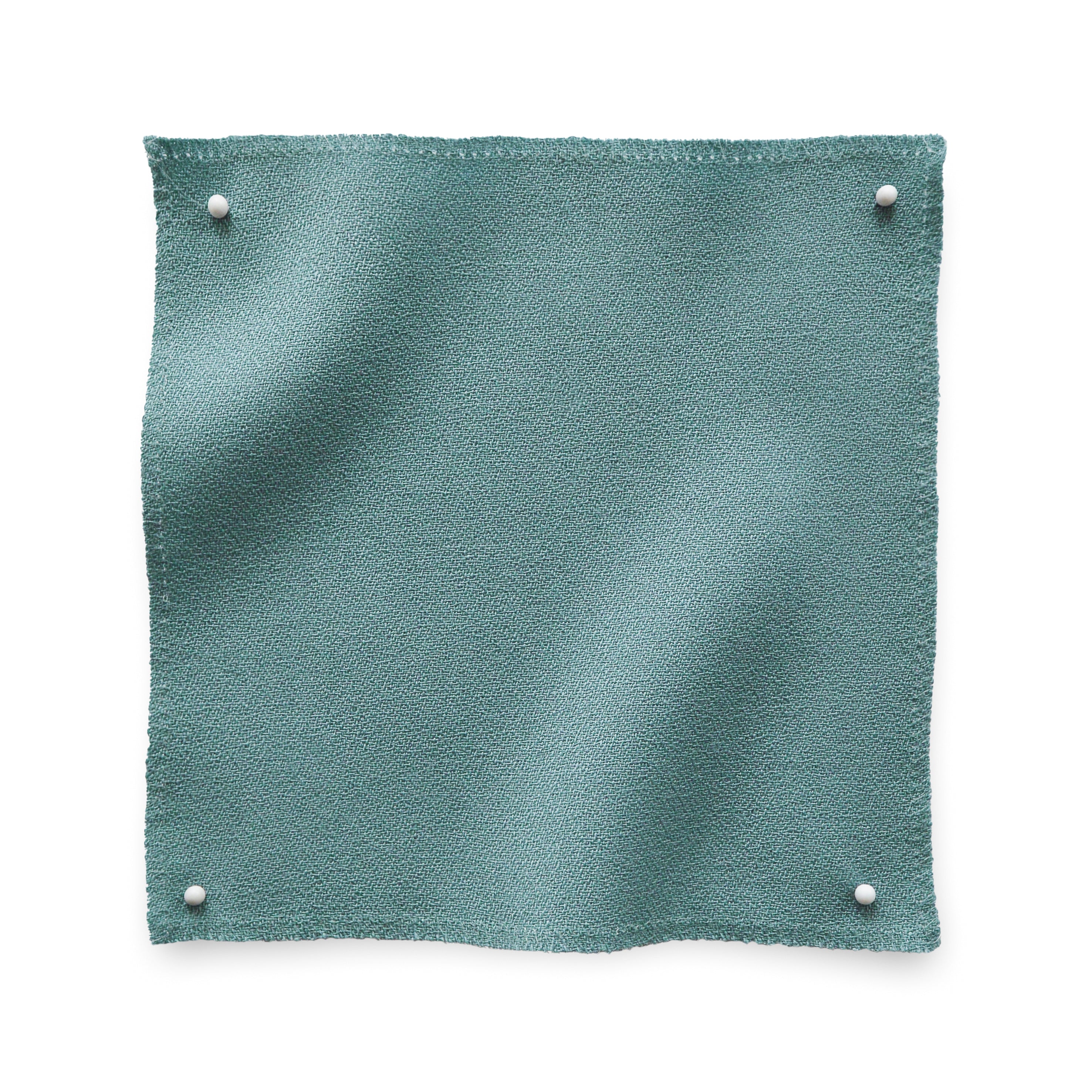 Wool crepe swatch pinned in all corners in sea green