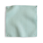 Wool sateen swatch pinned in all corners in icy blue