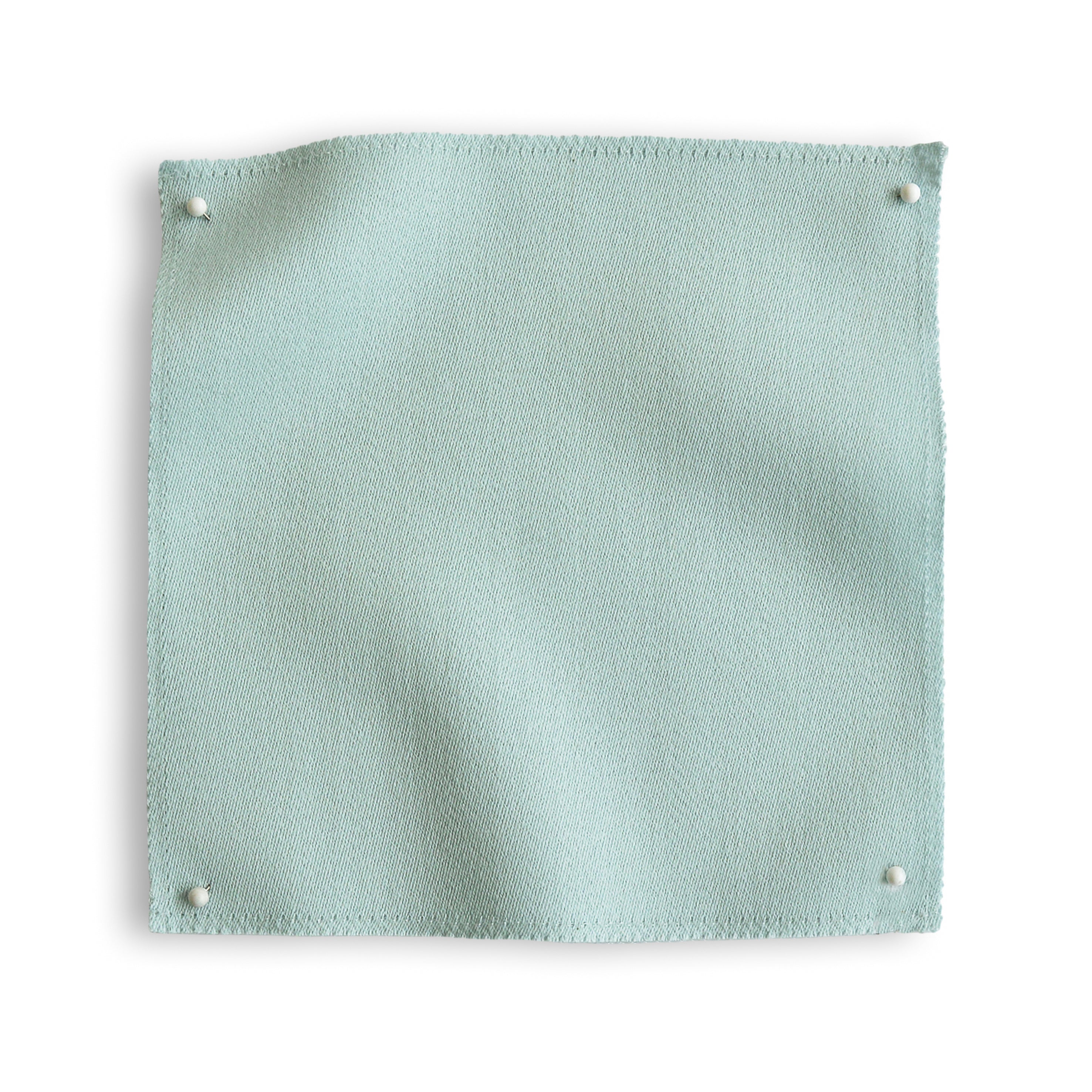 Wool sateen swatch pinned in all corners in icy blue