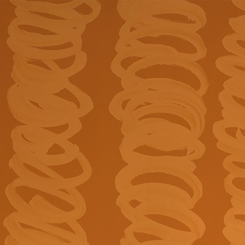 Detail of wallpaper in an abstract scribble print in orange on a rust field.