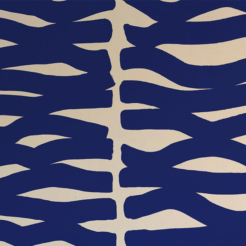 Detail of wallpaper in an abstract zigzag pattern in navy on a tan field.