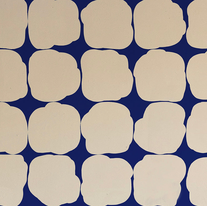 Detail of wallpaper in a repeating blot print in cream on a navy field.