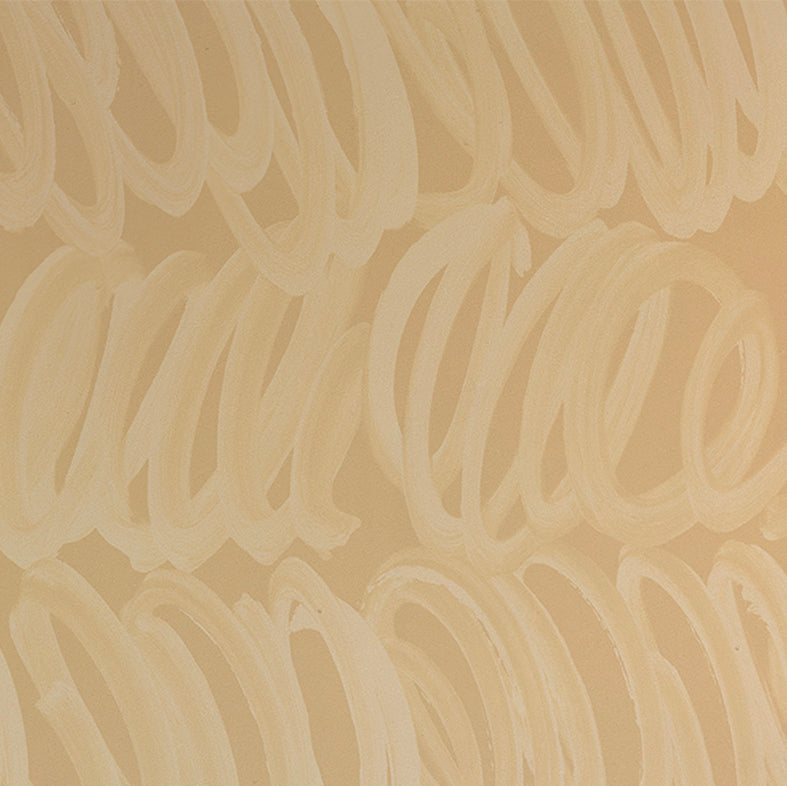 Detail of wallpaper in a playful paint print in cream on a tan field.