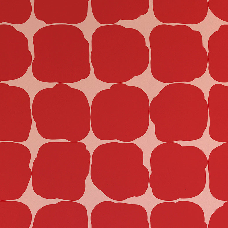 Detail of wallpaper in a repeating blot print in red on a pink field.