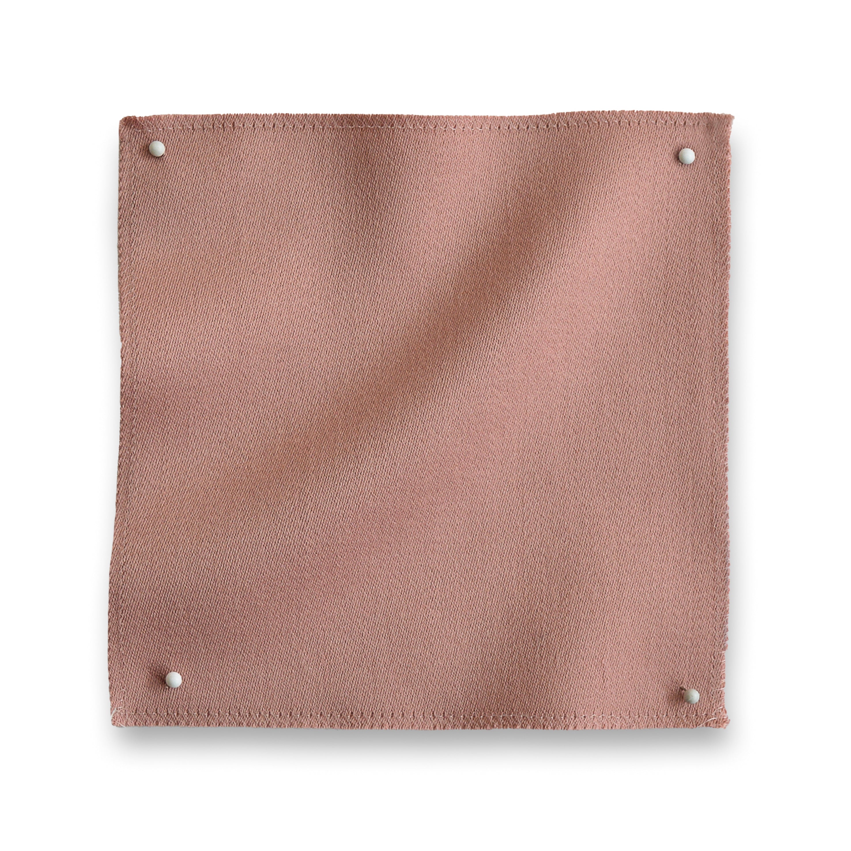 Wool sateen swatch pinned in all corners in blush pink