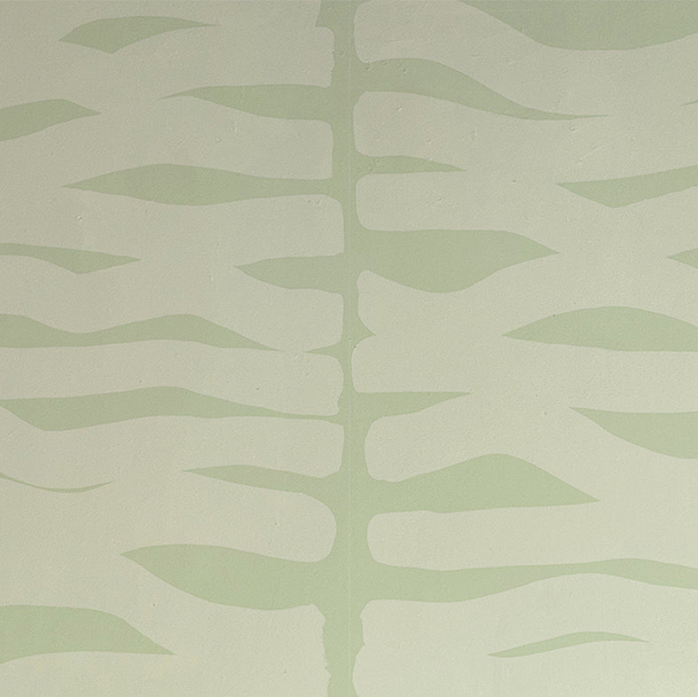 Detail of wallpaper in an abstract zigzag pattern in light green on a green field.