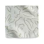 Square fabric swatch in a minimalist floral print in grass green on a cream field.