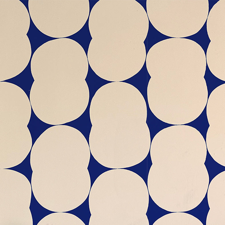 Detail of wallpaper in an abstract curvilinear pattern in cream on a navy field.