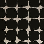 Detail of wallpaper in a repeating blot print in black on a white field.