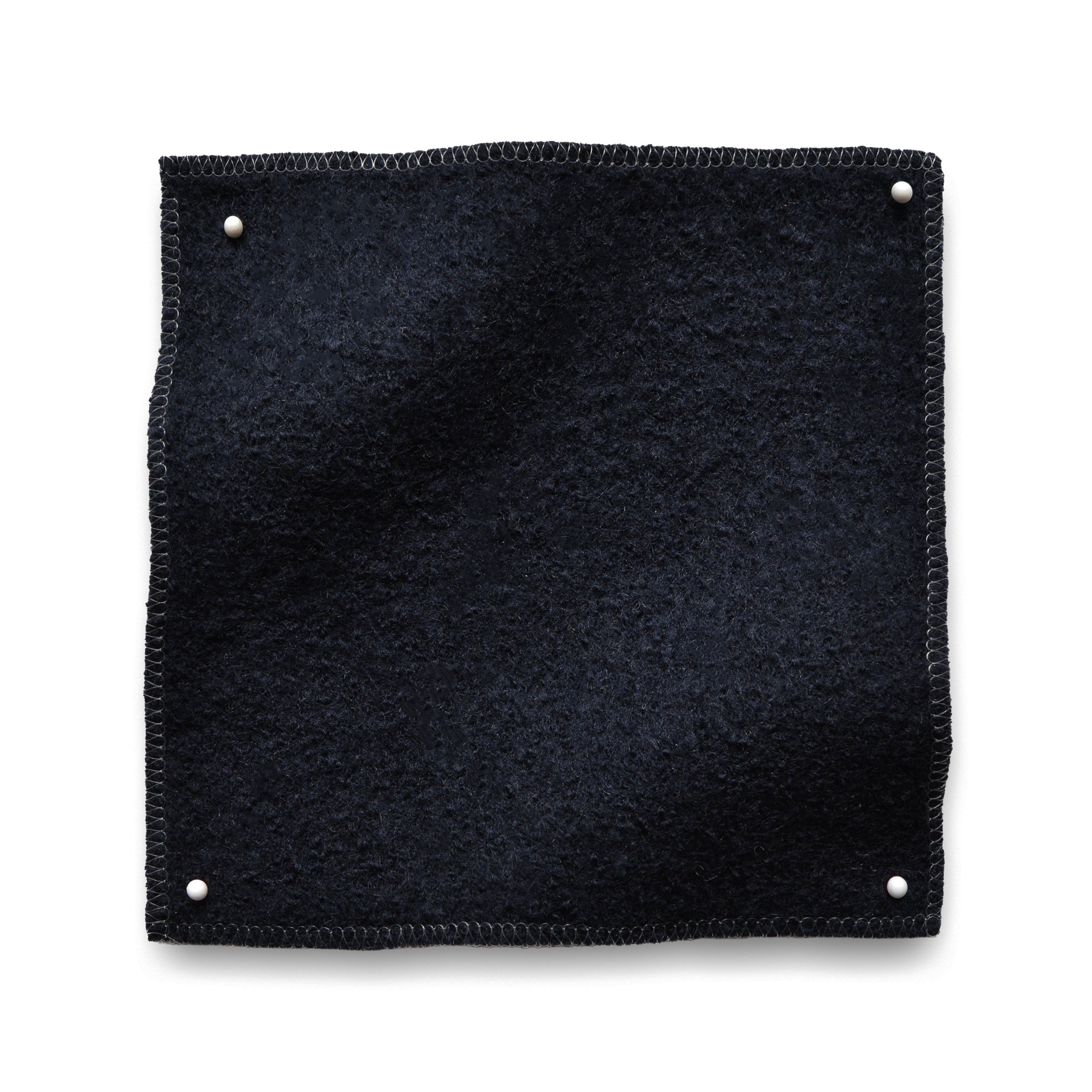 Wool boucle swatch pinned in all corners in dark navy blue