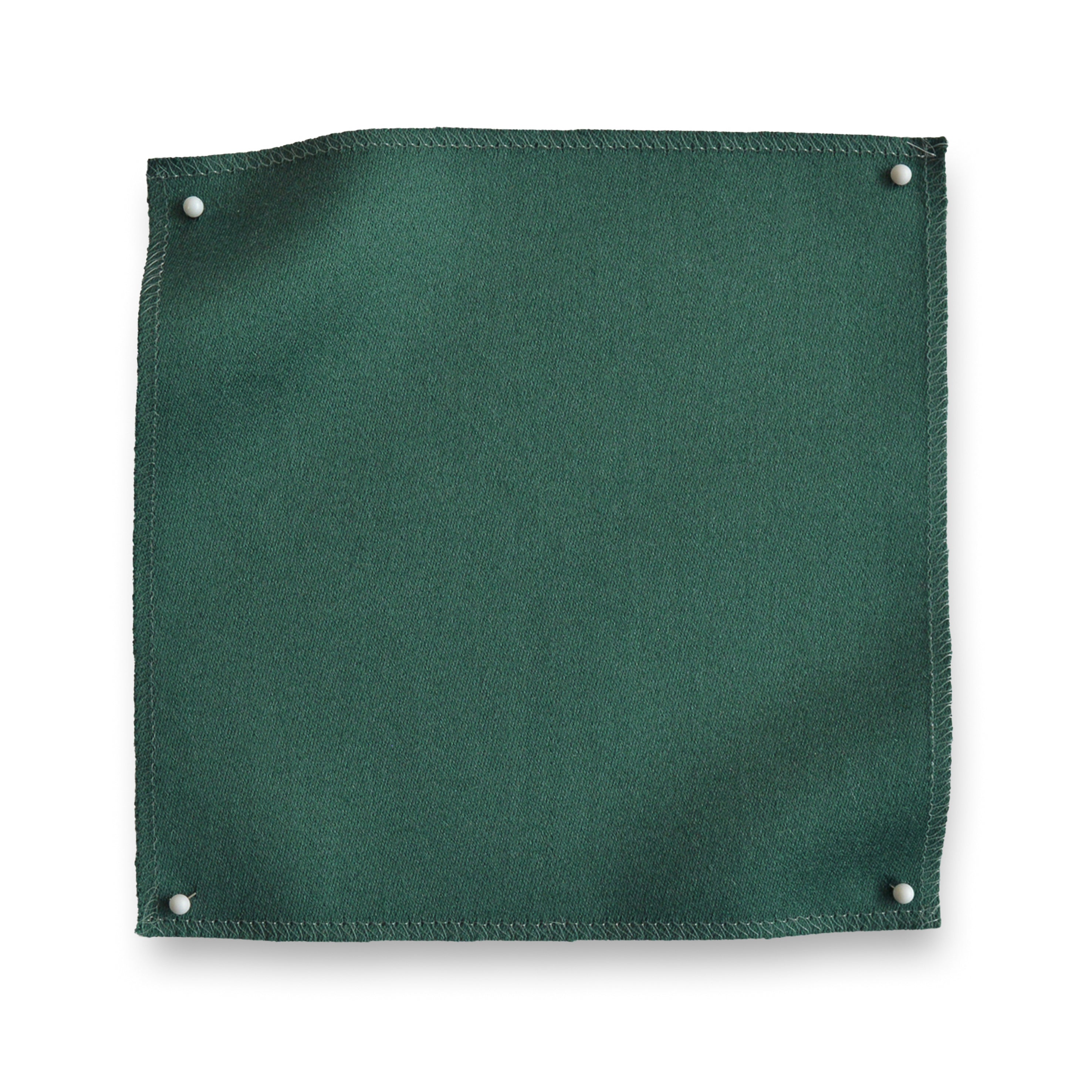 Wool sateen swatch pinned in all corners in green