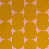 Detail of wallpaper in an abstract curvilinear pattern in mustard on a pink field.