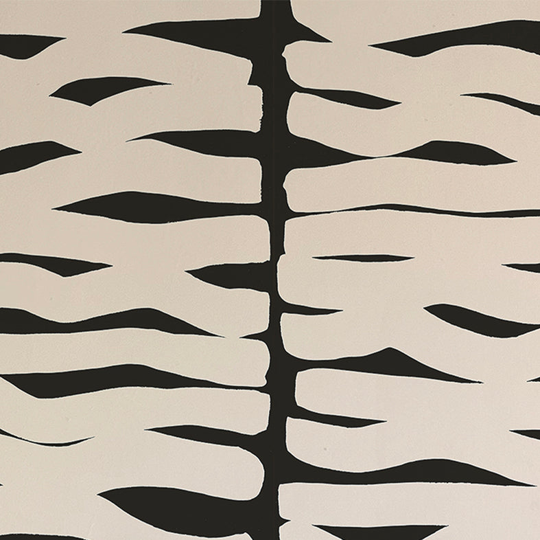 Detail of wallpaper in an abstract zigzag pattern in cream on a black field.