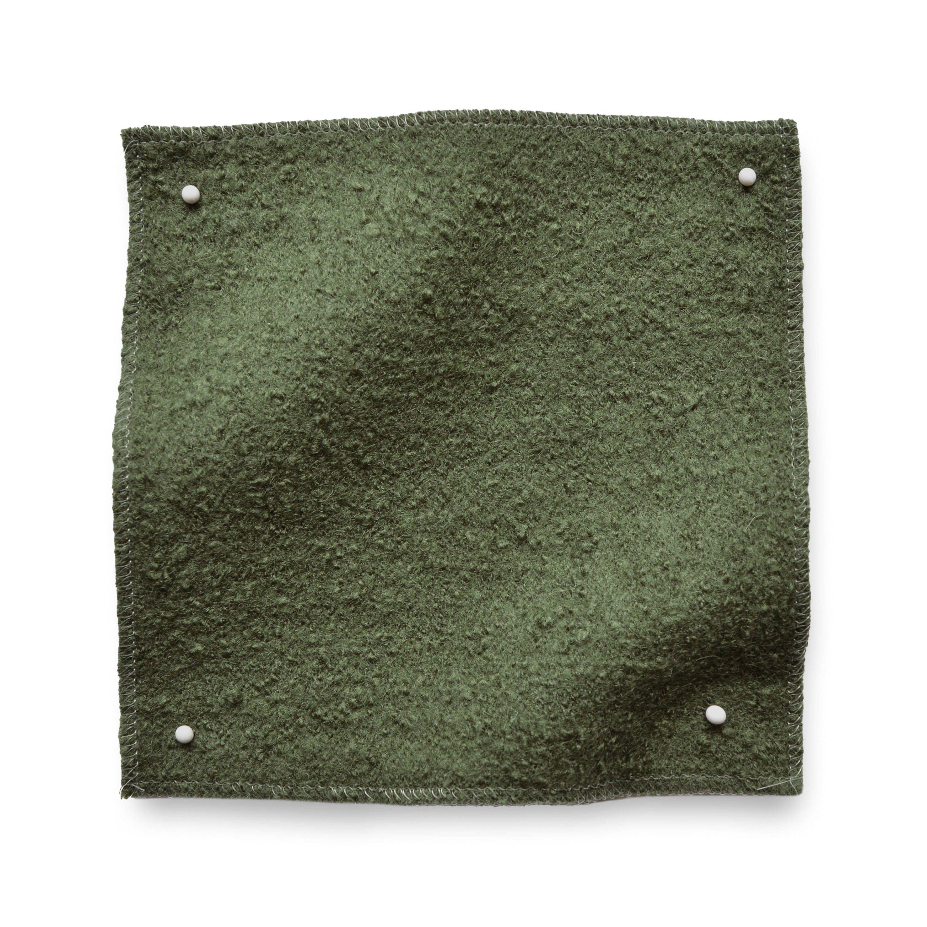 Wool boucle swatch pinned in all corners in army green