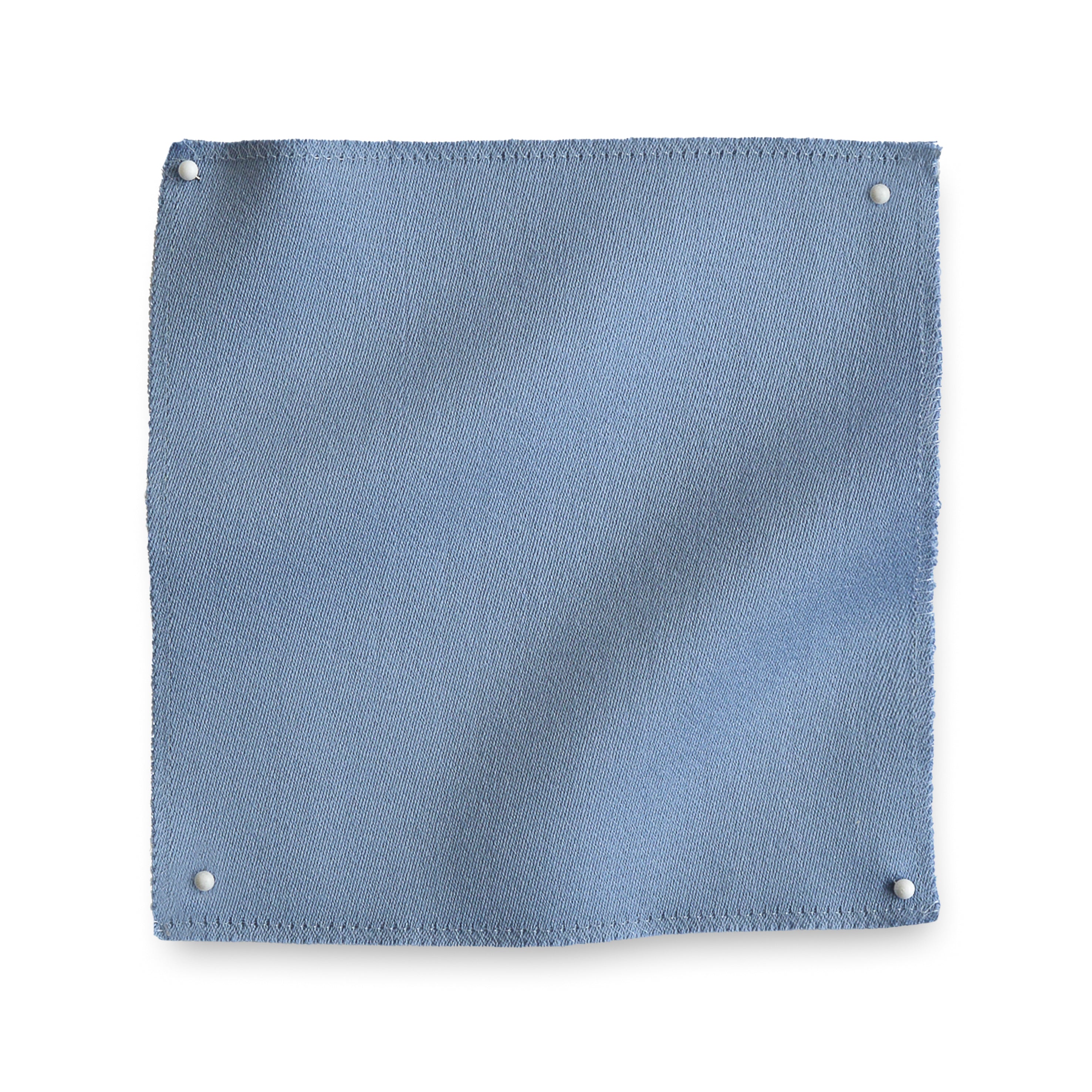 Wool sateen swatch pinned in all corners in cornflower blue