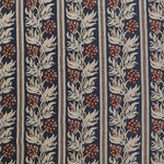 Woven performance fabric in a botanical branch and stripe design in beige, tan and red on a navy blue field. 