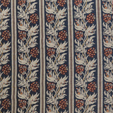 Woven performance fabric in a botanical branch and stripe design in beige, tan and red on a navy blue field. 