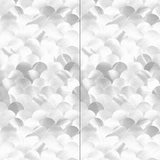 Wallpaper panels in a repeating scalloped print in shades of gray and white.