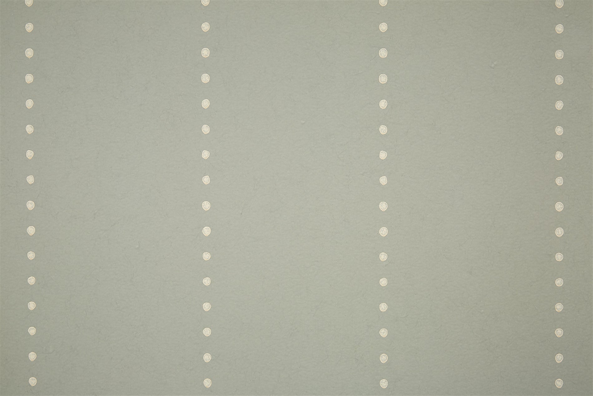 Detail of wallpaper in a minimalist dotted stripe pattern in cream on a gray field.