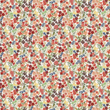 Detail of fabric in a dense small-scale floral print in shades of coral, red, green and blue on a white field.