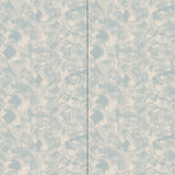 Wallpaper in an abstract paint swatch print in light blue on a tan field.