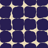 Detail of wallpaper in a repeating blot print in dark blue on a cream field.