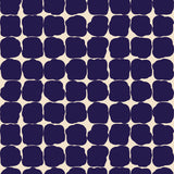 Wallpaper in a repeating blot print in dark blue on a cream field.