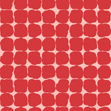 Wallpaper in a repeating blot print in red on a pink field.