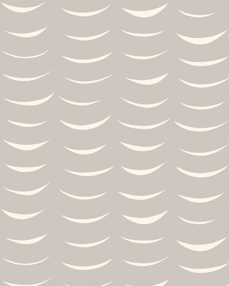 Detail of wallpaper in an abstract crescent print in cream on a gray field.