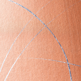 Wide-angle shot of wallpaper in an abstract curved line pattern in metallic silver on an orange field.
