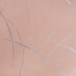 Detail of a wallpaper in an abstract curved line pattern in metallic silver on a pink field.