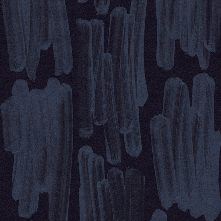 Detail of wallpaper in an abstract paint swatch print in blue on a black field.