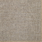 Close-up of a textured beige broadloom carpet with a subtle pattern