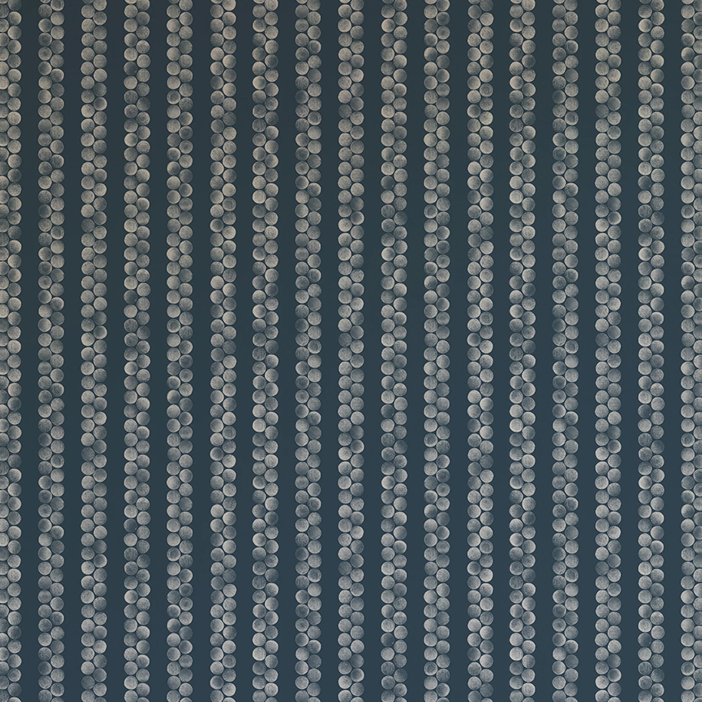 Detail of wallpaper in a repeating striped circular print in cream on a navy field.