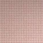 Detail of wallpaper in a dense plaid pattern in shades of cream and red.