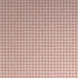 Detail of wallpaper in a dense plaid pattern in shades of cream and red.