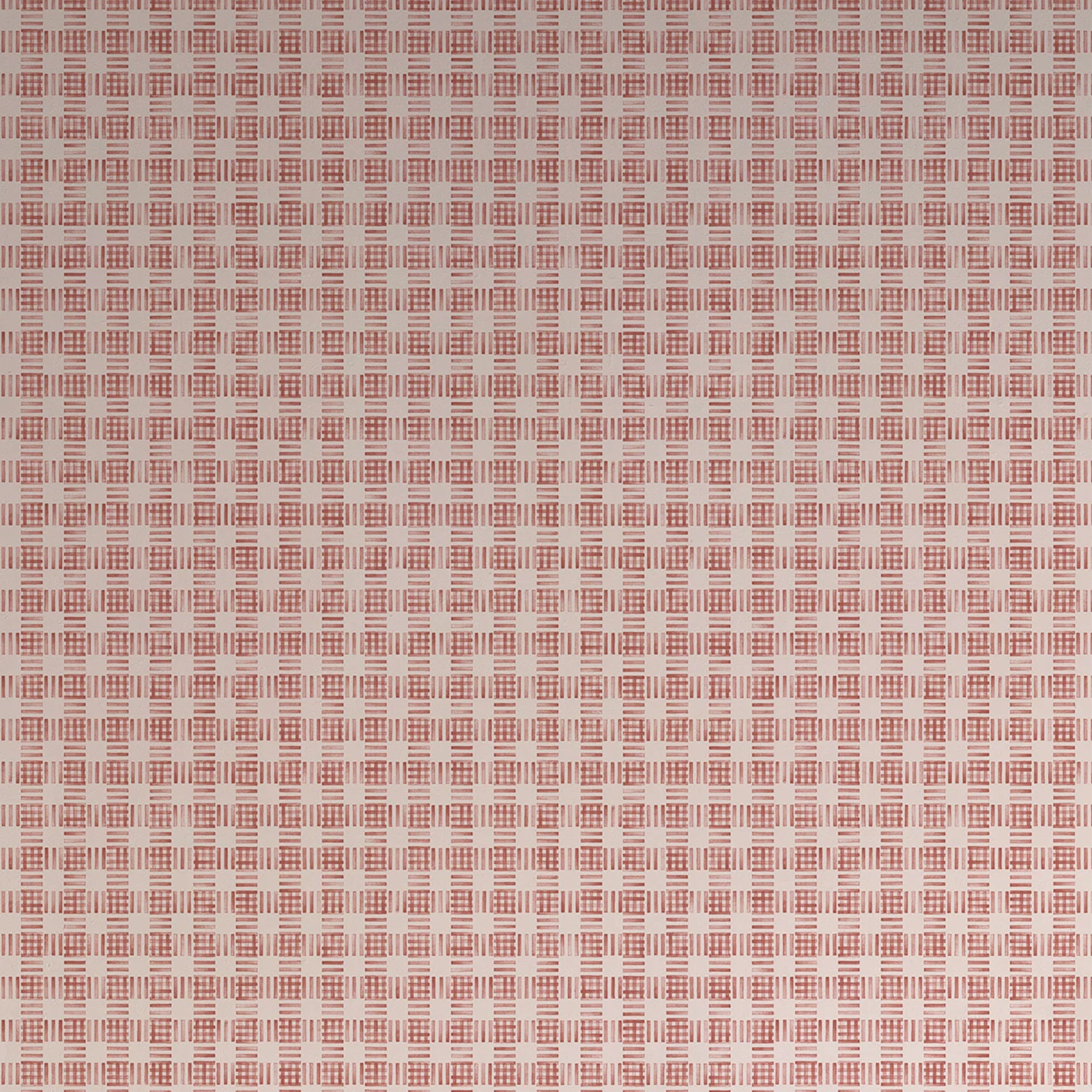 Detail of wallpaper in a dense plaid pattern in shades of cream and red.