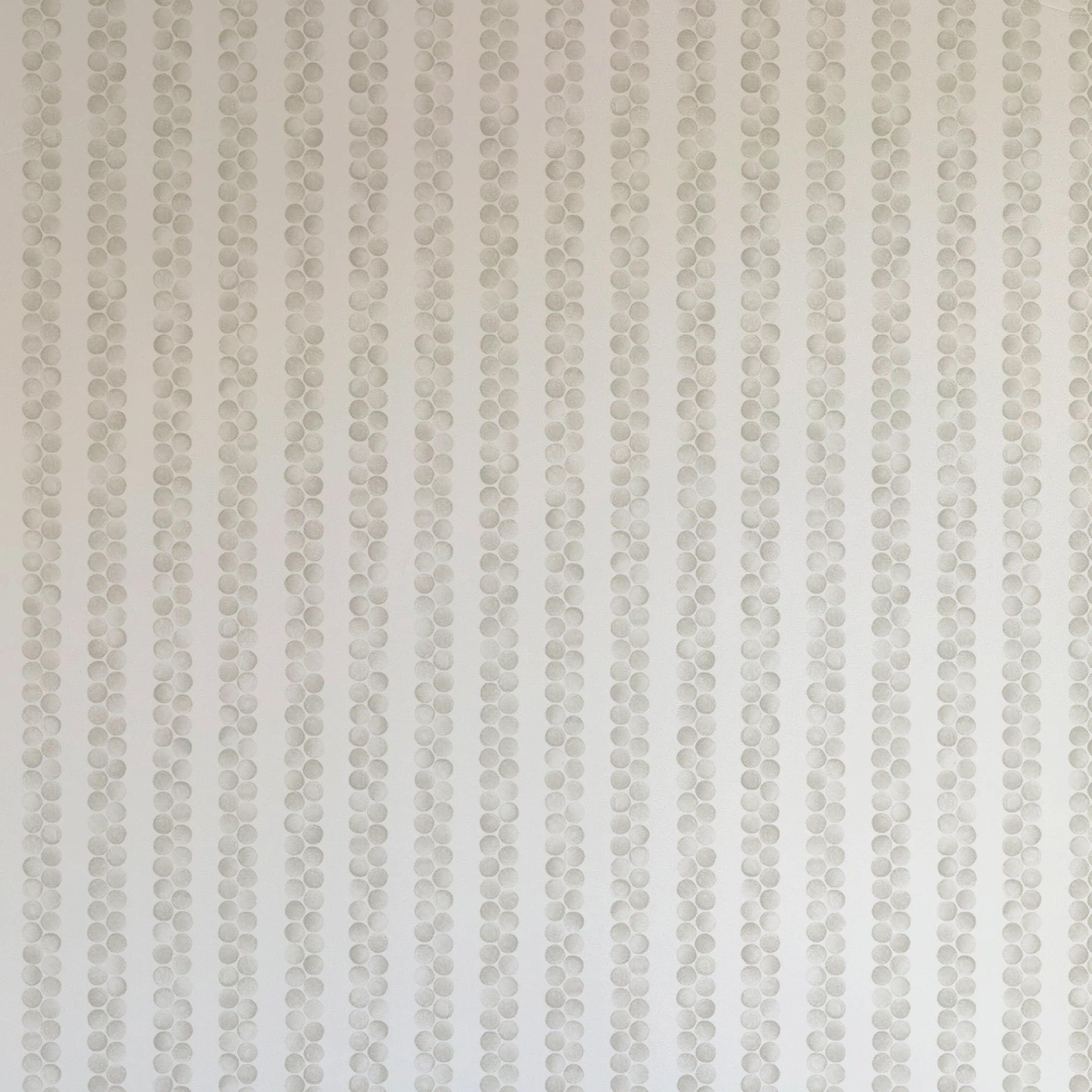 Detail of wallpaper in a repeating striped circular print in gray on a light gray field.