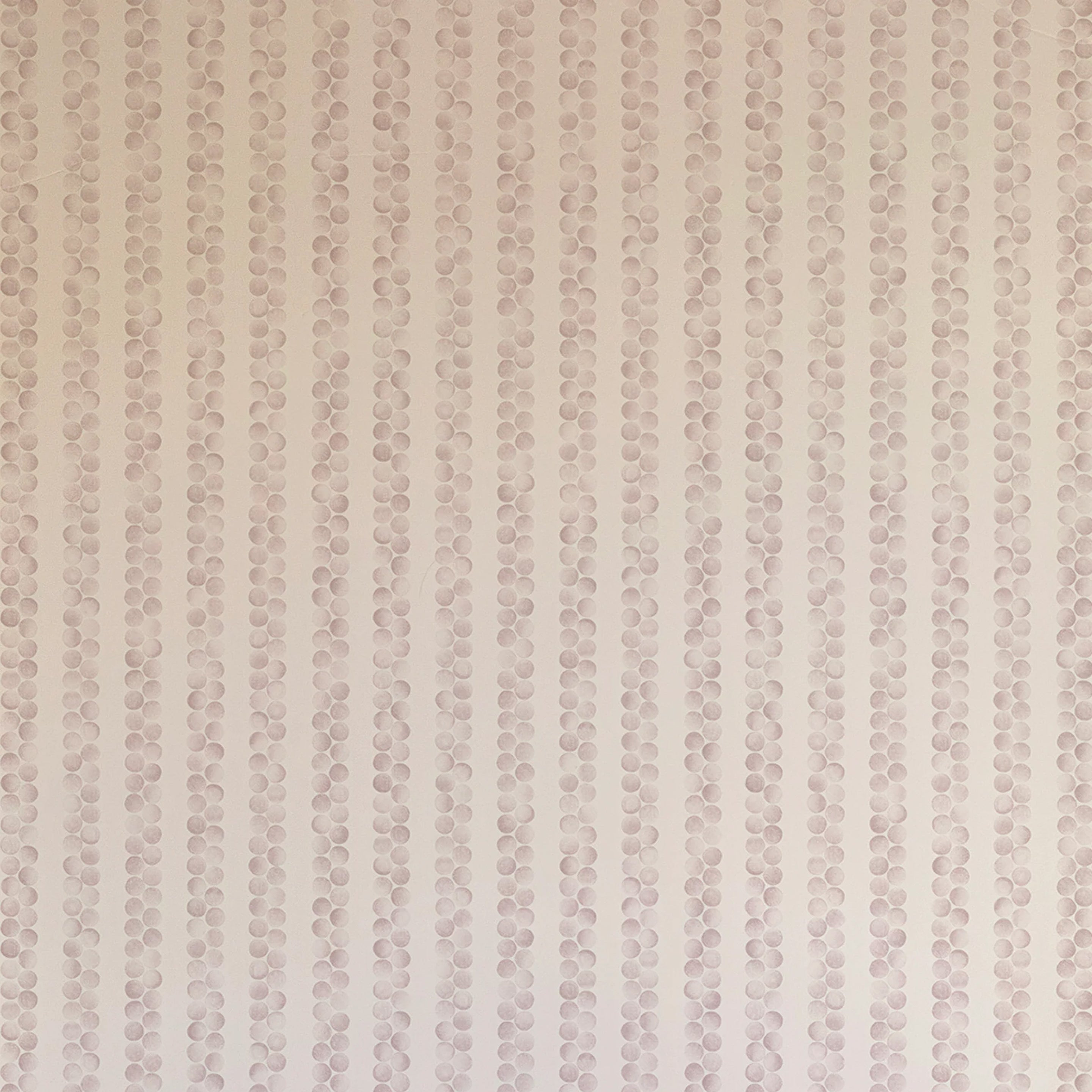 Detail of wallpaper in a repeating striped circular print in purple on a cream field.