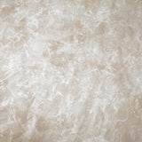 Detail of upholstery leather in cream with a marble overlay in white.