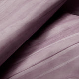 Draped cowhide rug in purple with an abstract stripe overlay in shades of purple and cream.